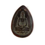 A Chinese carved horn amulet of the seated Buddha, H. 7cm.