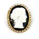 A yellow metal (tested 18c gold) carved agate cameo brooch / pendant set with split pearls, 4 x 3.