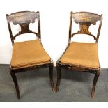 A pair of trompe l'oeil decorated 18th century sabre legged chairs.