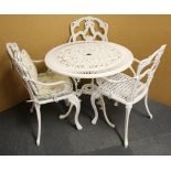 A painted metal garden table and three chairs.