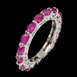 A 925 silver oval cut ruby set full eternity ring, (Q).