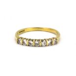 An 18ct yellow gold diamond set half eternity ring, (O).