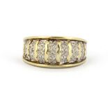 A 9ct yellow and white gold diamond set ring, (N.5).