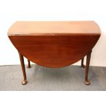 A 1920's oval mahogany dropleaf dining table, W. 108cm.