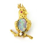 A yellow metal (tested 18ct gold) bird shaped brooch set with ruby eye, diamond and opal triplet, L.