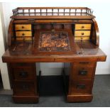 A small 19th century mahogany veneered rolltop desk with a pull out and adjustable writing