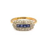 A boxed platinum and 18ct yellow gold (stamped 18ct & plat) ring set with sapphires and diamonds, (