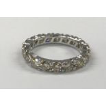 An 18ct white gold diamond set full eternity ring, approx. 2.84ct overall, (O).