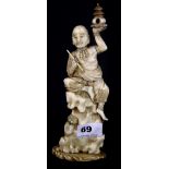 A 19th Century Japanese carved ivory okimono of a sage sitting on a rock, H. 22.5cm.