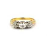 A yellow and whtie metal (tested 18ct gold) ring set with three old cut diamonds, approx. 1ct
