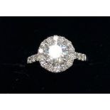 An 18ct white gold diamond set halo ring, set with an 0.92ct brilliant cut centre, approx. 1.4ct