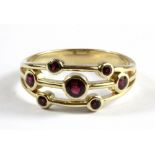 A 9ct yellow gold Boodles style ruby set ring, (Q).