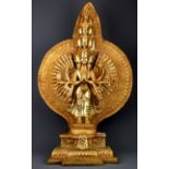 A large Tibetan gilt bronze temple figure of a thousand armed multi-head deity, H. 70cm.