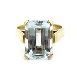 A yellow metal (tested minimum 9ct gold) ring set with a baguette cut aquamarine, approx. 7.73ct, (