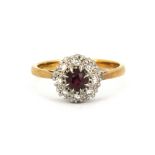 A boxed 18ct yellow and white gold ruby and diamond set cluster ring, (N.5).