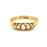 An 18ct yellow gold ring set with five graduated split pearls, (N).