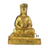 A Tibetan gilt bronze figure of a seated Lama, H. 20cm.