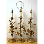 Three French gilt bronze floral candle sticks mounted as table lamps, with silk shades, H. 70cm.