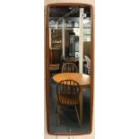 A 1970's teak backed wall mirror, H. 95cm.