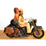 A resin model of a couple on a motorcycle, H. 38cm.