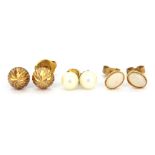 A pair of 9ct yellow gold opal set stud earrings with two further pairs of 9ct gold stud earrings.