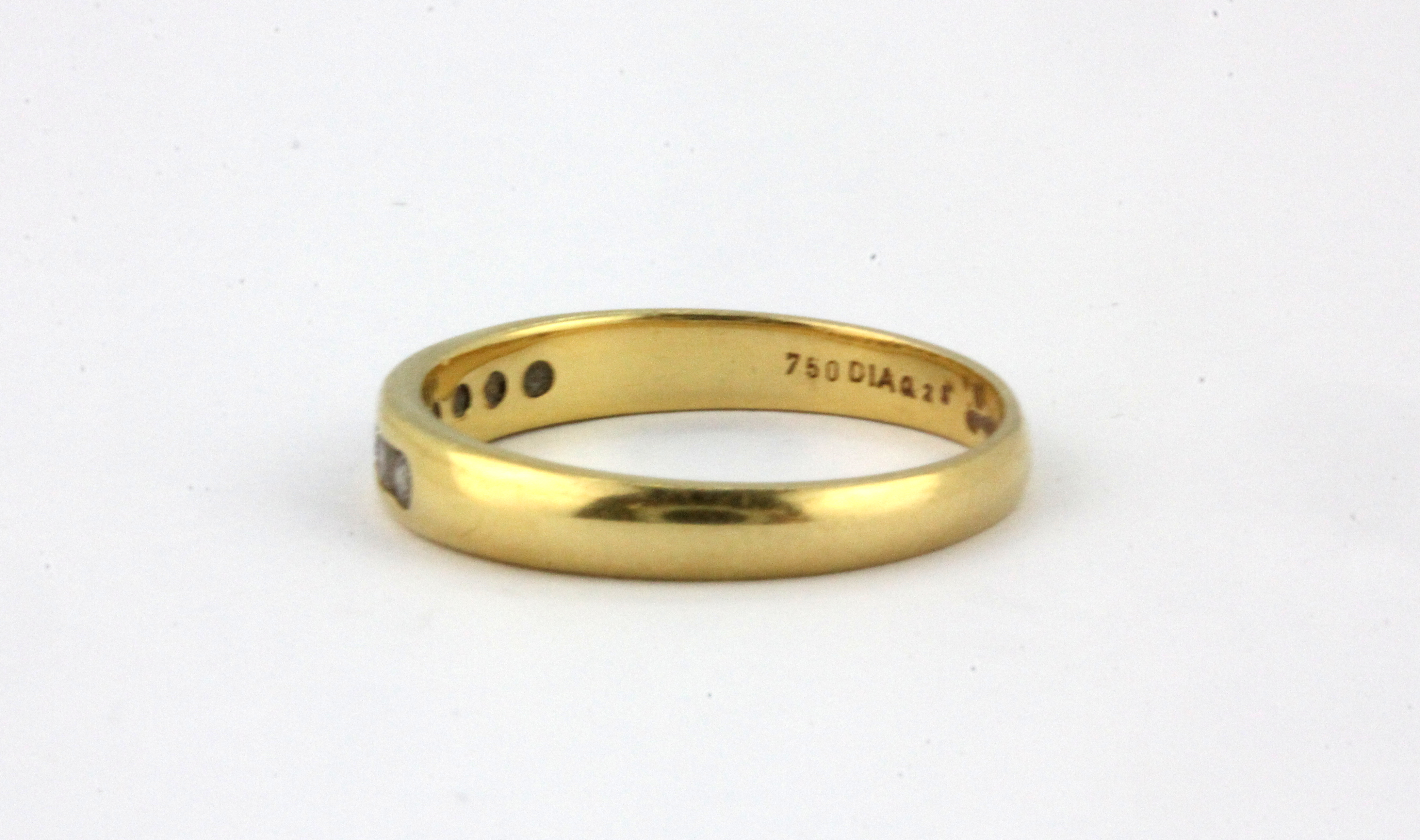 An 18ct yellow gold (stamped 750) half eternity ring set with brilliant cut diamonds, (N). - Image 2 of 2