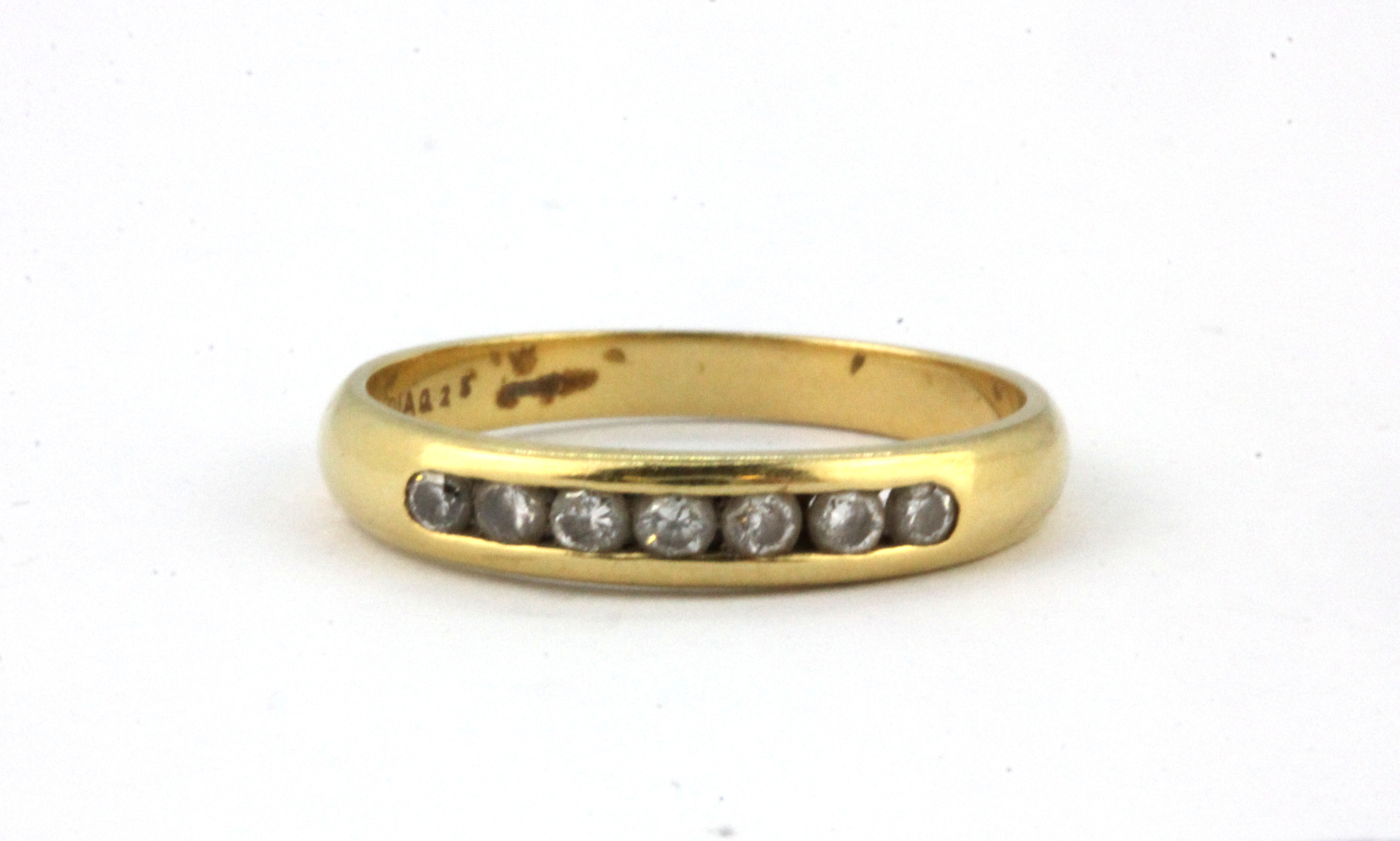 An 18ct yellow gold (stamped 750) half eternity ring set with brilliant cut diamonds, (N).