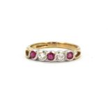 A 9ct yellow and white gold half eternity ring set with rubies and diamonds, (L.5).