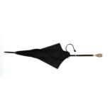A Victorian umbrella with white metal multi headed handle.
