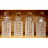 A set of four cut crystal decanters, H. 21cm.