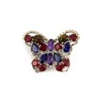 A 925 silver butterfly shaped brooch set with sapphires, rubies, amethyst and fire opals, L. 3cm.