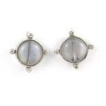 A pair of white metal (tested minimum 9ct gold) moonstone and diamond set screw back fitted earrings