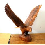 A large carved wooden figure of an eagle, H. 69cm.