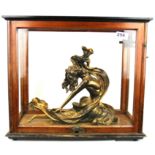 A figure of a dancer in a glazed cabinet, cabinet H. 40cm.