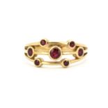 A 9ct yellow gold Boodles style ruby set ring, (Q).