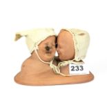 An amusing 19th century terracotta figure of two babies, H. 10cm.