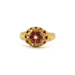 An 18ct yellow gold cluster ring set with rubies and rose cut diamonds, (M).