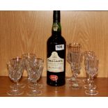 A bottle of Grahams 1994 port with a small group of glasses.