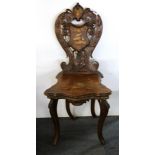 A 19th century hand carved and decorated hall chair.