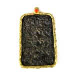 A Tibetan gilt metal mounted bronze mantra pendant, inset with coral, 7.5 x 4.5cm.