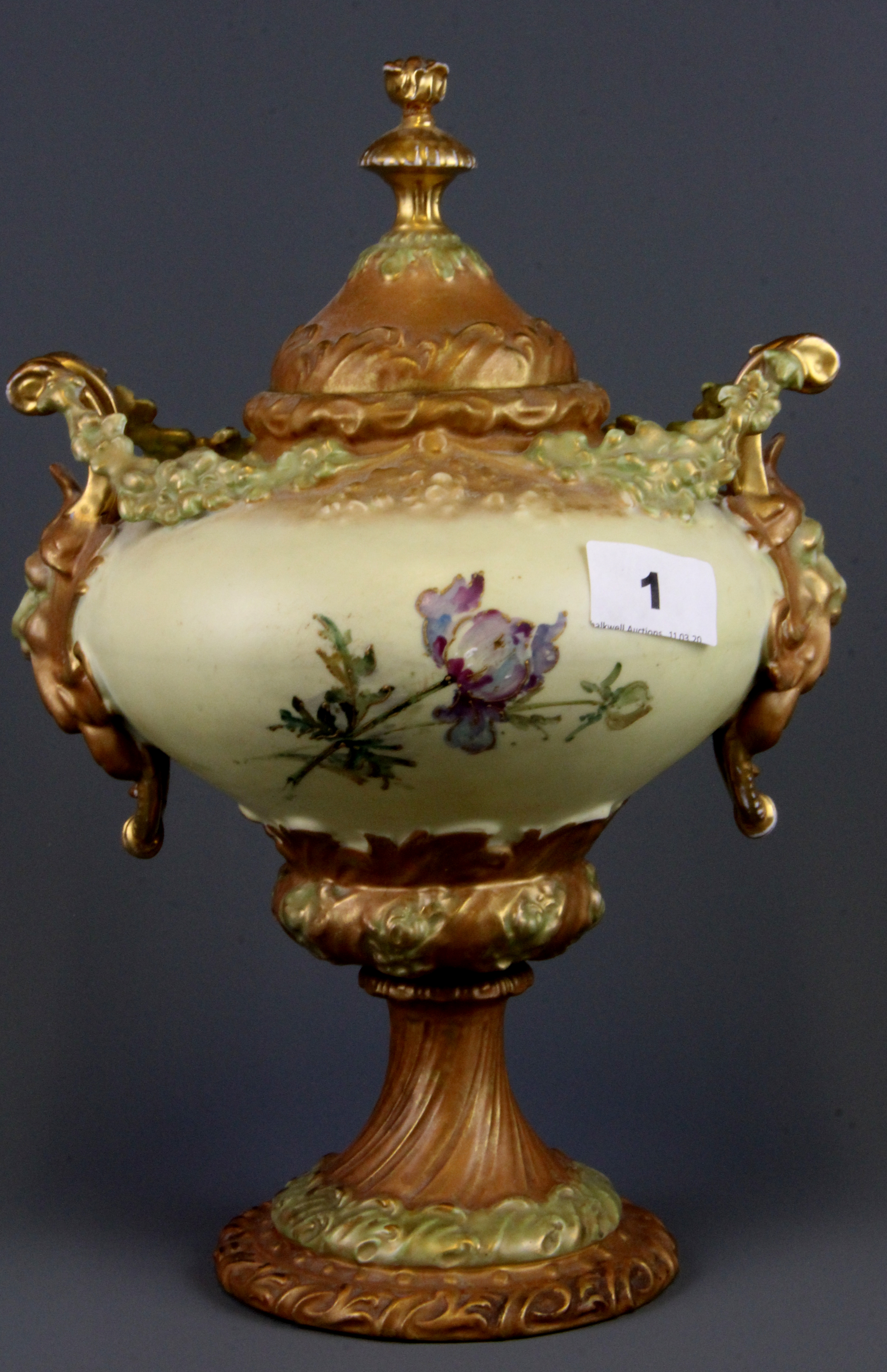 A 19th Century hand painted Continental porcelain urn and lid with green man handles, H. 30cm. - Image 2 of 3