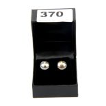 A pair of large 10mm black cultured pearl earrings on silver mounts.