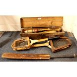 A vintage croquet set with a cricket bat and ball and two vintage tennis rackets.