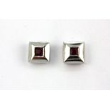 A pair of 9ct yellow and white gold (stamped 375) stud earrings set with rubies, L. 0.6cm.