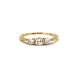 An 18ct yellow gold ring set with three brilliant cut diamonds, (J).