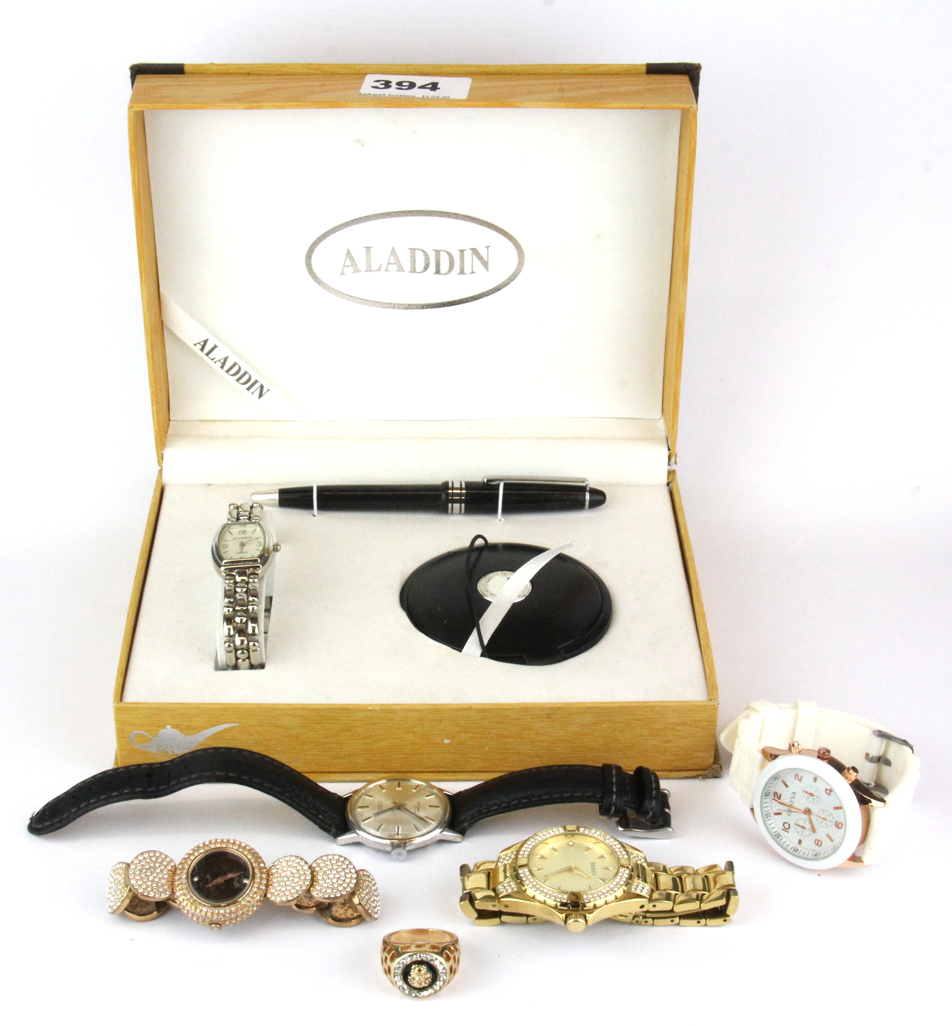 A lady's watch and pen set with further watches and jewellery.