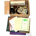 A box of mixed interesting small items and books.