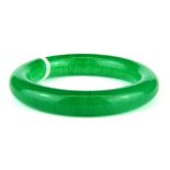 A Chinese polished green jade bangle.