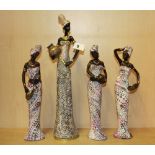 A group of four figurines of African women, tallest 43cm.
