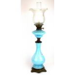 A 19th century opaline glass oil lamp with etched glass shade, H. 81cm.